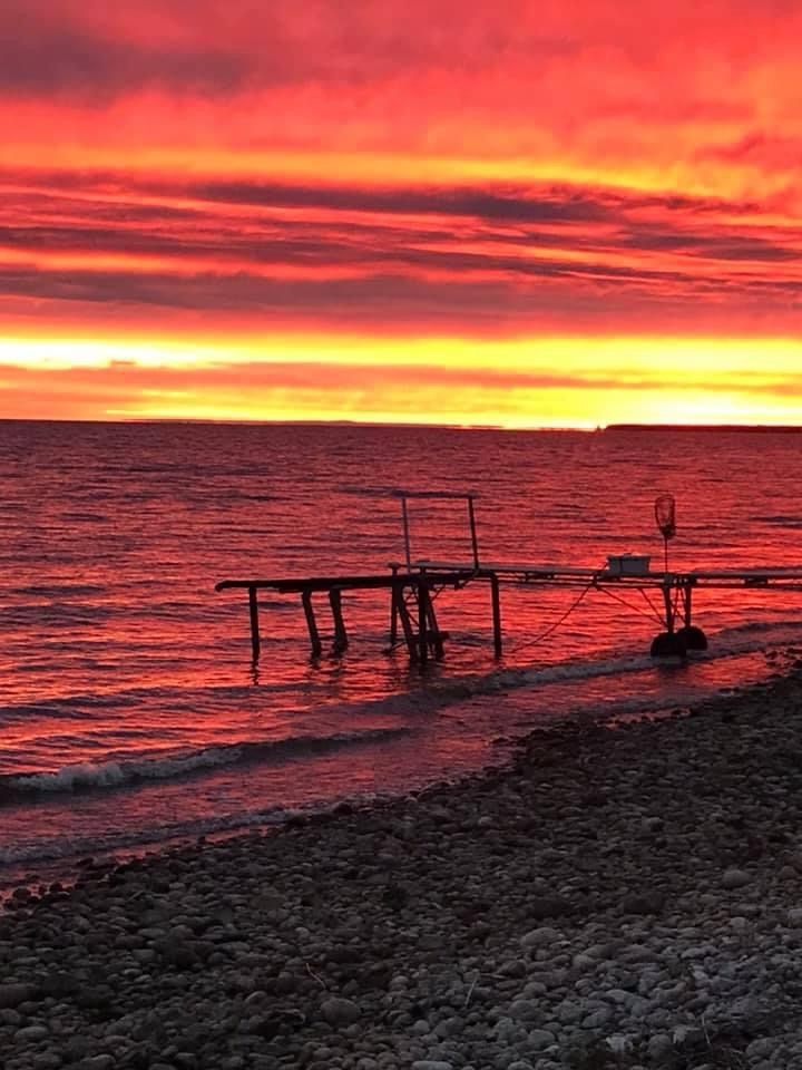 A fiery red sunset behind the dock