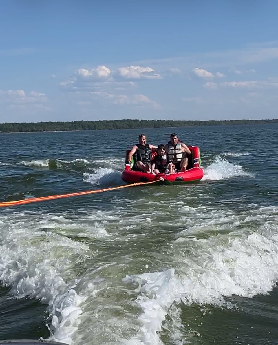 Tubing behind the boat on a summer afternoon